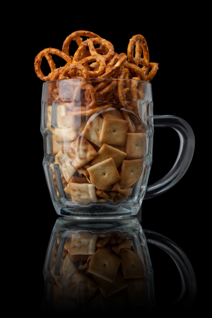 Beer snacks. Salty crackers and pretzels. Isolated on blackの写真素材