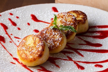 Cottage cheese pancakes with raspberry syrupの写真素材