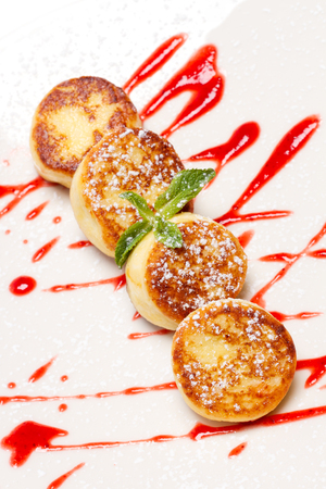 Cottage cheese pancakes with raspberry syrupの写真素材