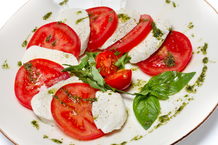 Caprese salad photo on white dishの写真素材