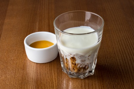 Granola in a glass cereal with yogurt and honeyの写真素材