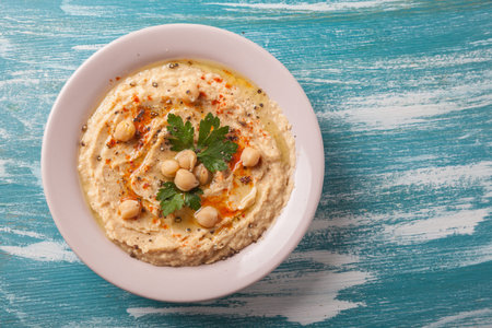 vegan food. hummus with parsley and smoked paprika