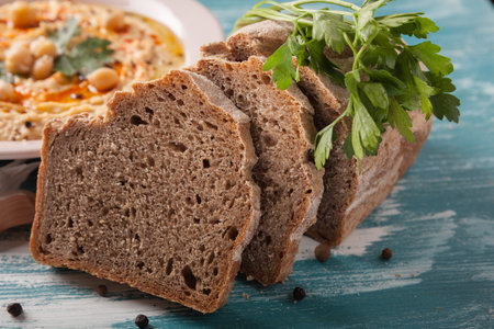 homebaked whole wheat rye black bread with hummus