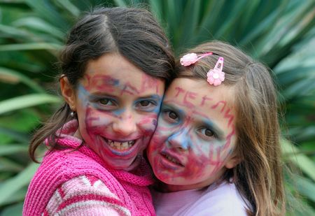 Two young girls with faces painted for carnivalの写真素材