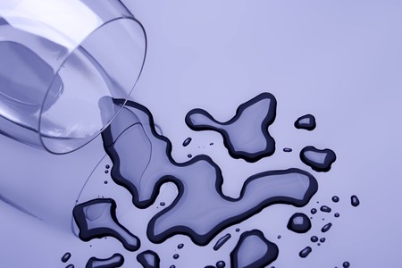 Glass of clear drinking water on reflective surfaceの写真素材