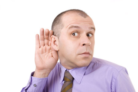 Middle aged businessman holding hand on his ear