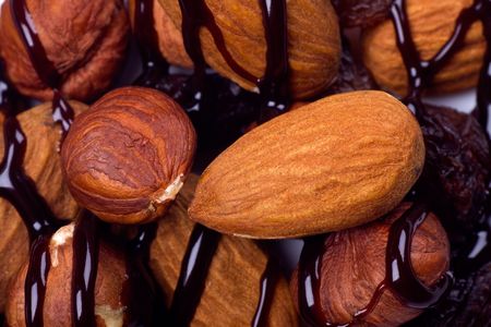 Hazelnut, almond and raisins covered with chocolate toppingの写真素材