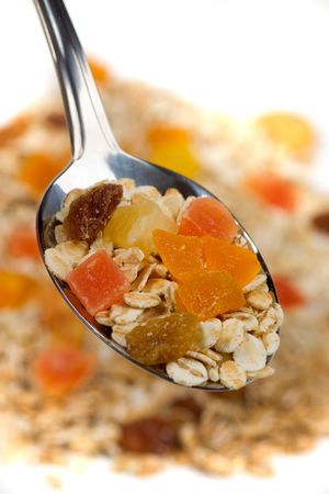 Muesli with dried fruit in a spoonの写真素材