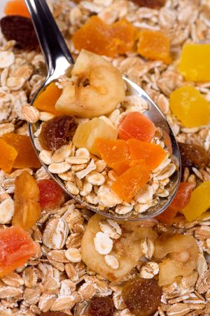 Muesli with dried fruit in a spoonの写真素材