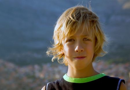 Beautiful young boy with long blond hairの写真素材