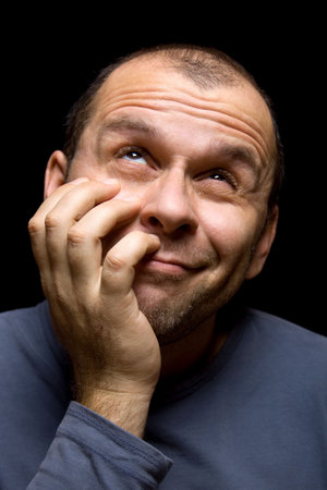 Adult man thinking of something that make him smile