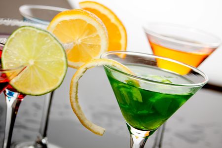 Colorful cocktail drinks with lemon, orange and lime slicesの写真素材