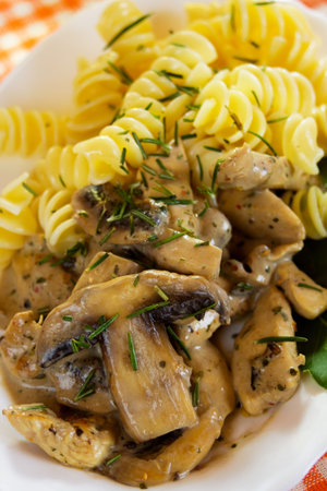Portabello or champignon mushrooms with chicken meat and pasta