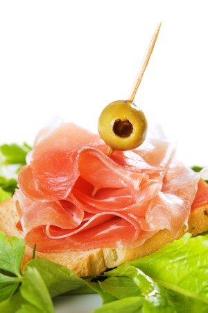 Prosciutto, italian cured ham with green olive and lettuceの写真素材
