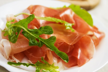 Rocket salad and prosciutto, traditional italian cured hamの写真素材