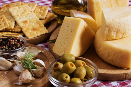 Homemade hard cheese with olives, garlic and rosemaryの写真素材