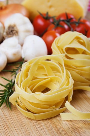 Italian fettuccine pasta and other food ingredients ready for cookingの写真素材