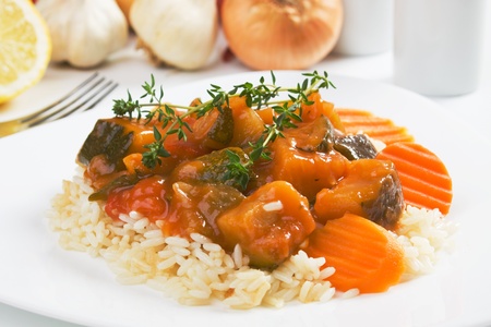 Zucchini and other vegetables in sauce served over cooked riceの写真素材