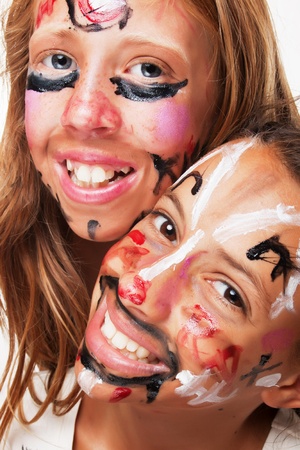 Two young girls with faces painted for carnival paradeの写真素材