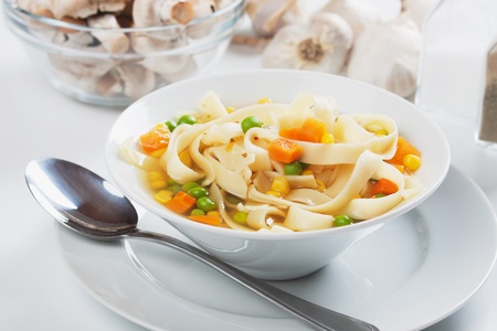 Healthy noodle soup with carrot, green peas and cornの写真素材