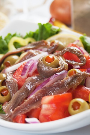 Anchovy salad with olives and tomato, classic italian foodの写真素材