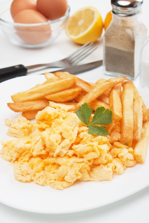 Scrambled chicken eggs served with french friesの写真素材