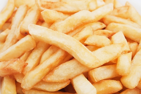 French fries, fried potato over white backgroundの写真素材