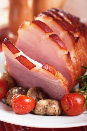 Roasted ham with mushrooms and cherry tomatoの写真素材