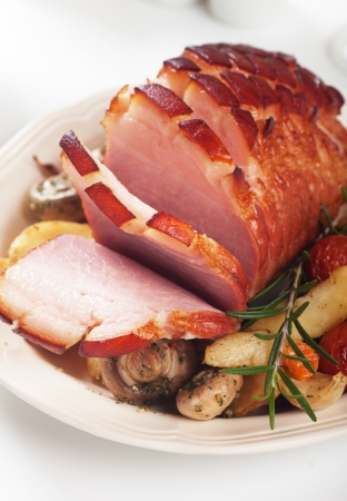 Roasted christmas ham with mushrooms and vegetablesの写真素材
