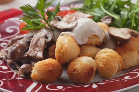 Roasted potato croquettes with portabello mushrooms and sauceの写真素材