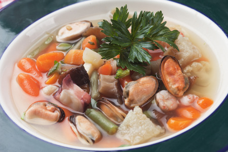 Seafood and vegetable soup with mussels, carrot and cod fishの写真素材