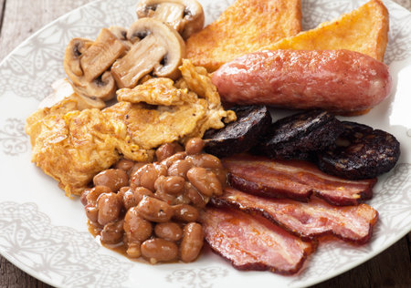 Full english breakfast with scrambled egg, bacon, mushrooms, sausage and kidney beans