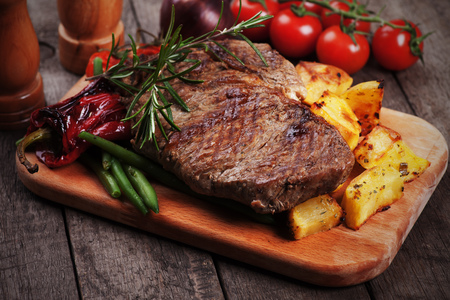 Beef rib-eye steak with roasted potato and vegetablesの写真素材
