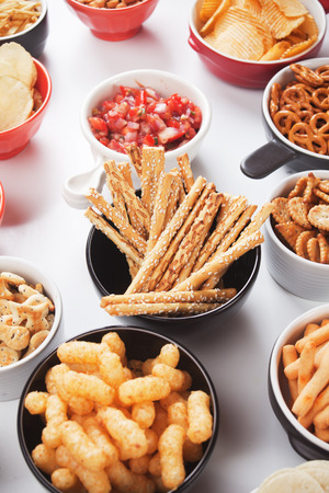 Salty grissini sticks with sesame seed and other savory snackの写真素材