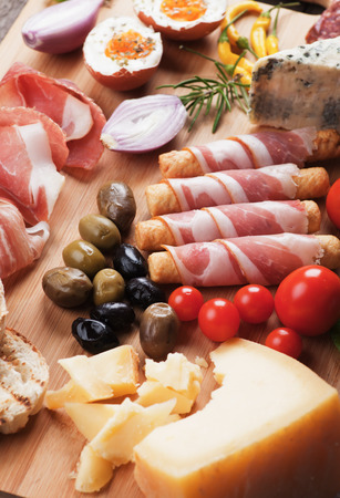 Prosciutto di Parma with olives and other italian antipasto foodの写真素材