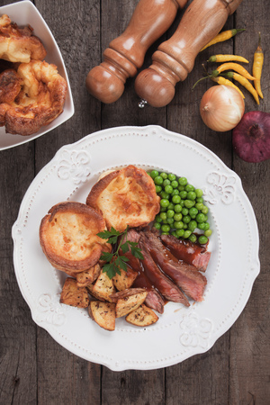 Traditional british sunday roast with yorkshire pudding, roasted potato and vegetablesの写真素材
