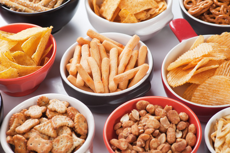 Grissini sticks, potato chips and other salty snacksの写真素材