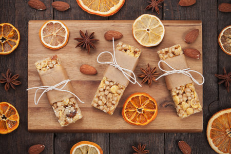 Granola bars with sereals and dried fruit on wooden boardの写真素材