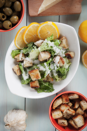 Classic caesar salad with lettuce, croutons, parmesan cheese and dressingの写真素材