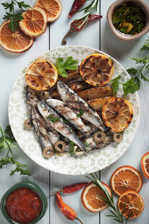 Grilled sardine fish with lemon and roasted potatoの写真素材