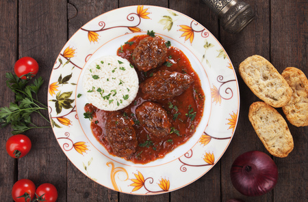 Kofta meatballs in tomato sauce served with cooked riceの写真素材