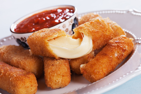 Breaded mozzarella cheese sticks served with tomato sauceの写真素材