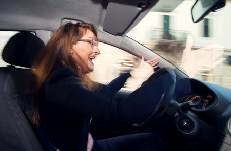 Nervous and bad tempered female driver yelling at other drivers in traffic