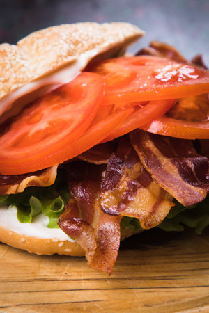 BLT sandwich with fried bacon, lettuce and tomato in slices of breadの写真素材