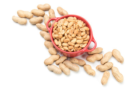 Roasted peanuts with peanut shells isolated on white background