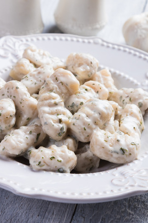 Gnocchi di patata, italian potato noodles in cheese and garlic sauceの写真素材