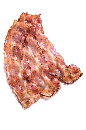 Slices of fried bacon isolated on white backgroundの写真素材