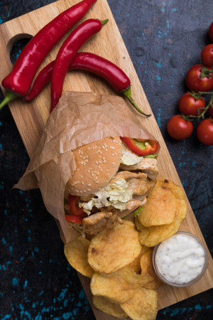 Sandwich with grilled chicken steak meat, tomato and lettuce