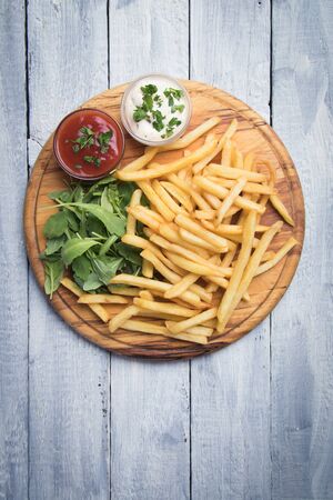 French fries, deep fried potato chips with ketchup and mayonnaiseの写真素材