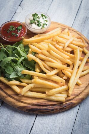 French fries, deep fried potato chips with ketchup and mayonnaiseの写真素材
